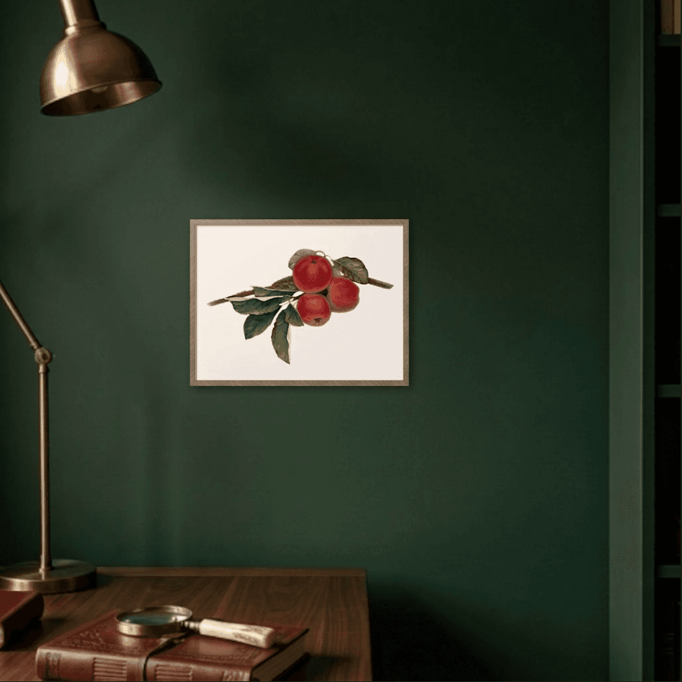 Harvest Moment framed on a deep green wall above a writing desk with a brass lamp